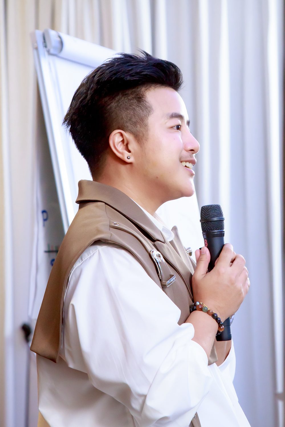 ฟิล์ม ดร.ทิชธาดา สิริธาระนน ยิ้ม ถือไมค์ระหว่างสอน